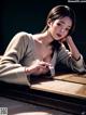 A woman laying on top of a wooden table.