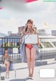 a japanese woman in a red panties is holding a sign